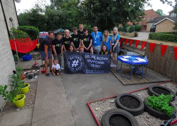 NCS teenagers show of their finished project, renovating the reception class garden at Kirkby La Thorpe School. EMN-180724-122414001