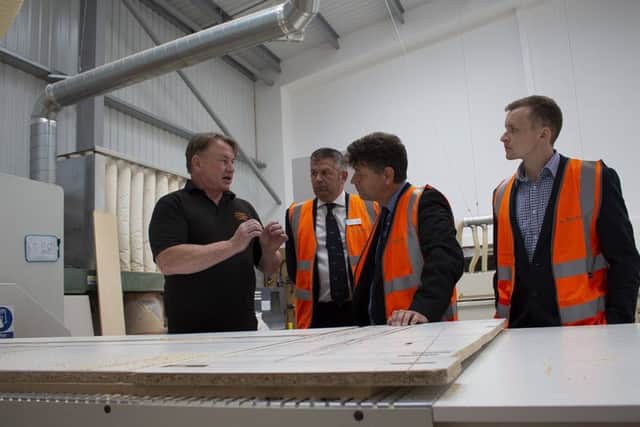 Andy Graham from Phoenix Kitchens shows NKDC's Leader Coun Richard Wright, Economic Development Manager Alan Gray and Lewis Mason of tenancy managing agents Lambert Smith Hampton around his new business unit, one of seven created by the £4.2m construction project. EMN-180717-172830001