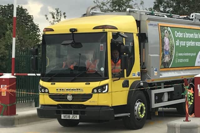 The dustbin lorry bursts through the ribbon to officially open NKDC's new waste and recycling fleet depot at Metheringham. Photo: NKDC EMN-180717-172602001