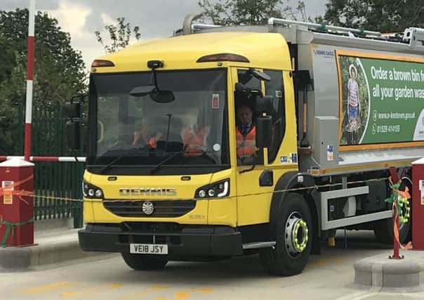 The dustbin lorry bursts through the ribbon to officially open NKDC's new waste and recycling fleet depot at Metheringham. Photo: NKDC EMN-180717-172602001