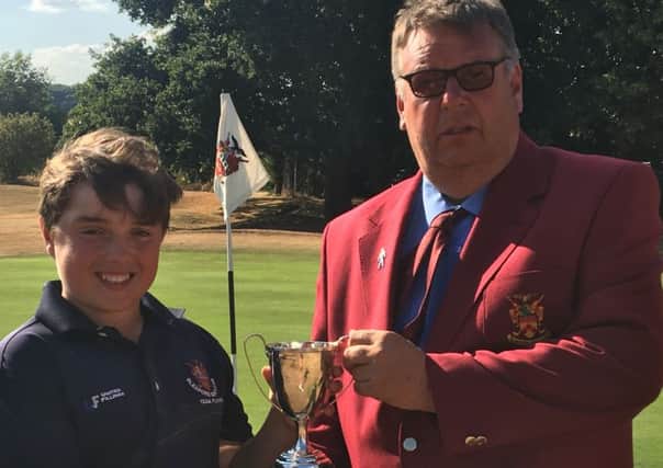 Michael receives the Sleaford Golf Club men's champion trophy from club captain Ian Addlesee EMN-180719-145117002