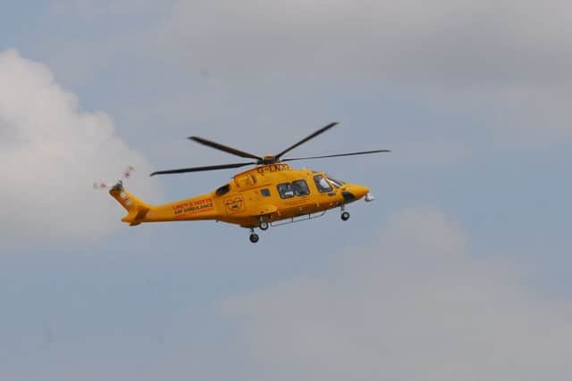 The air ambulance landing at Sleaford Cricket ground. EMN-180719-163310001