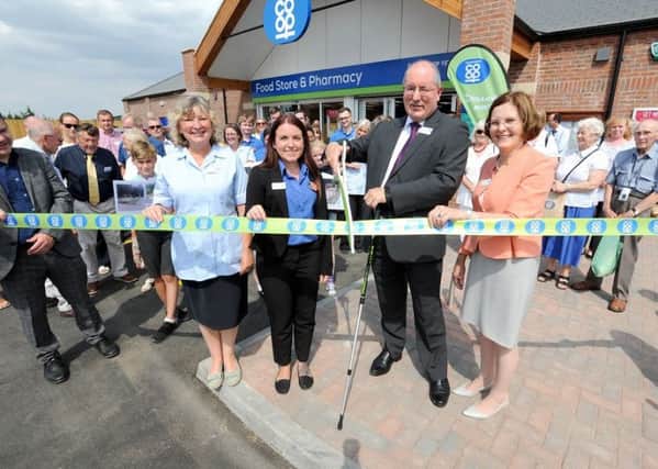 Cutting the ribbon at the new Â£1.6m Lincolnshire Co-op outlet in Swineshead.