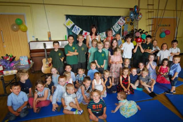 Heckington Pre-school manager Karen Barry gets a grand send-off by children and their families after being involved for 29 years. Pictured with new manager Emma Deakin. EMN-180726-163905001