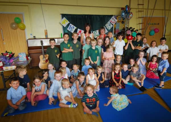 Heckington Pre-school manager Karen Barry gets a grand send-off by children and their families after being involved for 29 years. Pictured with new manager Emma Deakin. EMN-180726-163905001