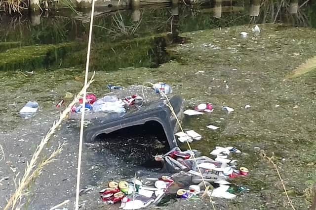 Polluting the River Slea. One of the recycling bins tossed in by yobs. Photos: Jane Peck EMN-180725-122057001