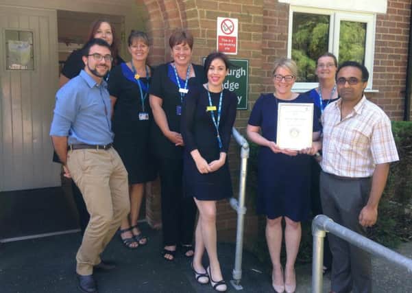 Staff at Tasburgh Lodge Surgery, in Woodhall Spa, with the award. EMN-180725-150849001