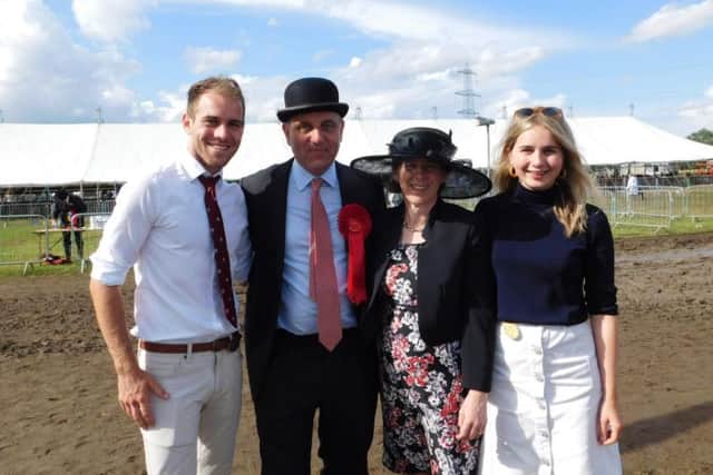 Heckington Show WILL go ahead despite yesterday's storms. Show committee chairman Charles Pinchbeck pictured with his family after last year's rain affected show.