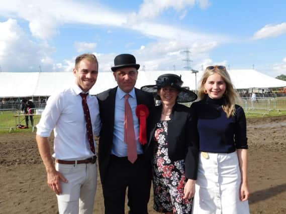 Heckington Show WILL go ahead despite yesterday's storms. Show committee chairman Charles Pinchbeck pictured with his family after last year's rain affected show.