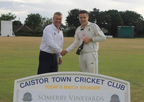 Market Rasen umpire Simon May presents First XI skipper Kieran Brooker with the man-of-the-match award, sponsored by Somerby Vineyards EMN-180730-112242002