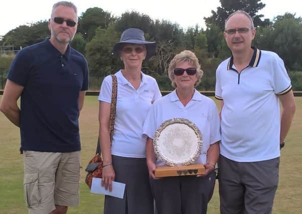 Turnbulls' Sleaford Plumbing branch manager Martin Pallister (left) presents the trophy to the winning set of, from left, Sandra Tebbs, Yvonne Smith and Ian Smith EMN-180731-084726002
