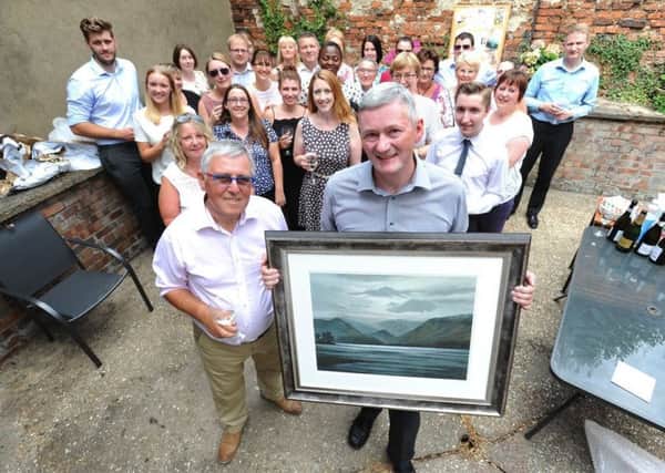 Robert Alcock holding the frame with Patrick Cordingley (left) and the rest of the Horncastle team. EMN-180731-160748001