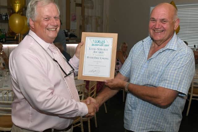 Peter Atterby (Luxus managing director) congratulates Peter Laking (maintenance and project engineering manager).