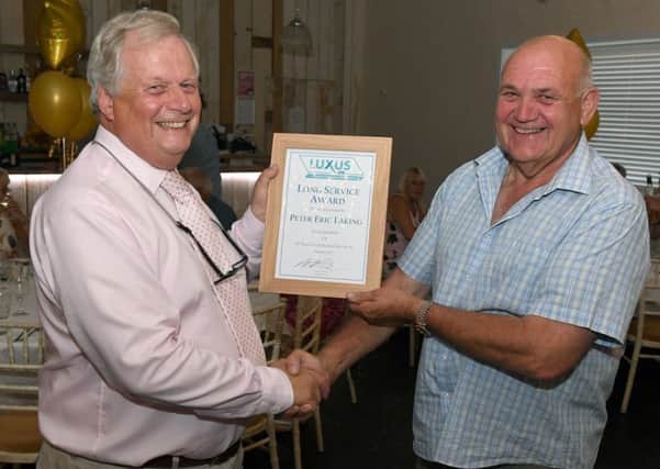 Peter Atterby (Luxus managing director) congratulates Peter Laking (maintenance and project engineering manager).
