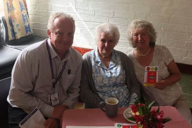Lincolnshires scambassador Stuart Tweedale talks to two residents  at the Age UK  Lindsey coffee morning in Horncastle