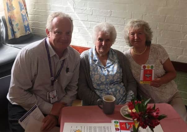 Lincolnshires scambassador Stuart Tweedale talks to two residents  at the Age UK  Lindsey coffee morning in Horncastle