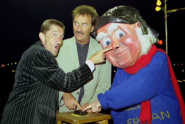 Barry Elliott (left) pictured with his brother Paul and the Jolly Fisherman switching on Skegness Illuminations in July 1997 on the rostrum at the Clock Tower. Photo: Ben Hardaker ANL-180508-122513001