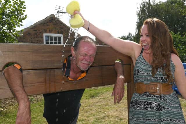 Claire Farrell - organiser of the Horncastle summer gala community day with Robin Tointon in the stocks.