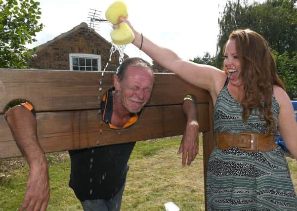 Claire Farrell - organiser of the Horncastle summer gala community day with Robin Tointon in the stocks.