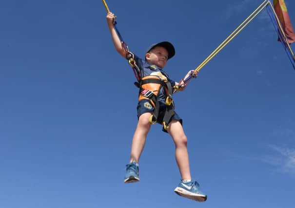 Up, up and away... Noah Williams (7) on the bungee trampoline. EMN-180608-091615001