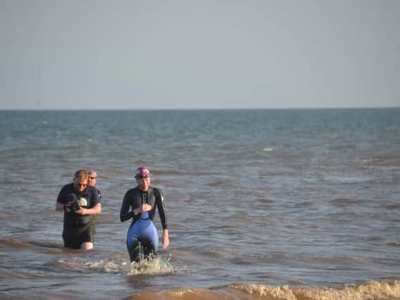 Claire arrives at Gibraltar Point after her 14-mile swim to raise money for a little girl with a rare form of cancer. Photo: Barry Robinson.