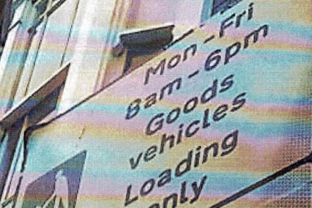 The parking sign pictured from the side by the parking enforcement team.