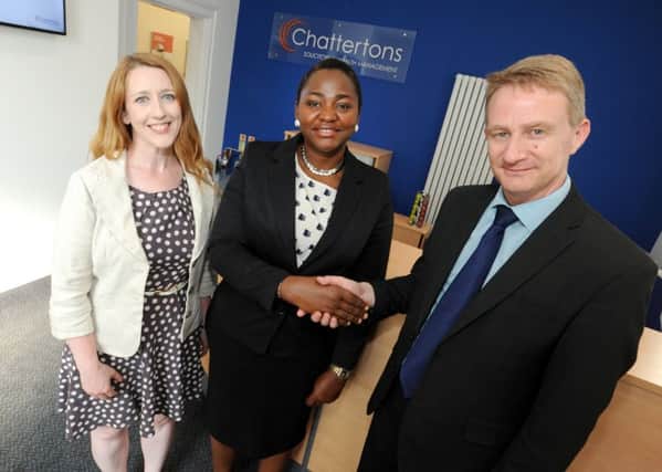 Ejiro Efekodo with new work colleagues Roly Freeman and Emma Blow . Chattertons Horncastle office