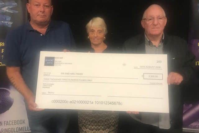 Craig Danskin, manager of Buzz Bar, presents a cheque to the parents of murdered Caroline Fisher, Margaret and Alf Fisher. ANL-180813-122811001
