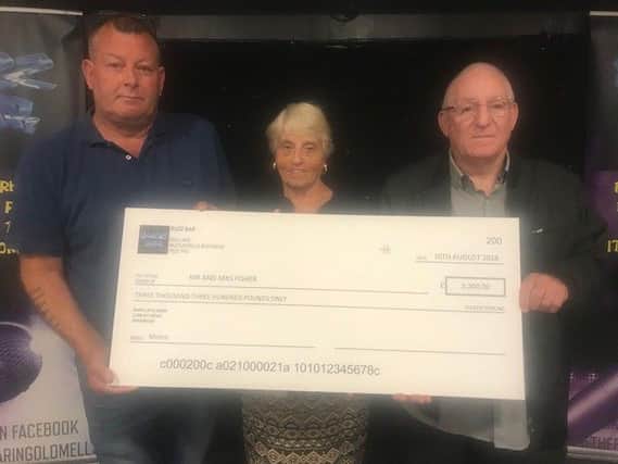 Craig Danskin, manager of Buzz Bar, presents a cheque to the parents of murdered Caroline Fisher, Margaret and Alf Fisher. ANL-180813-122811001