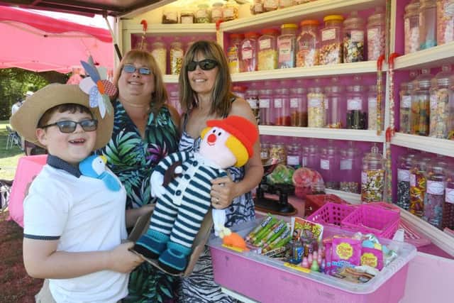 Family Fun Day at St George's Academy. L-R Wolf Mileham 8, Annie Mason and Brenda Mileham in front of Cottage Candy stall. EMN-180813-110643001