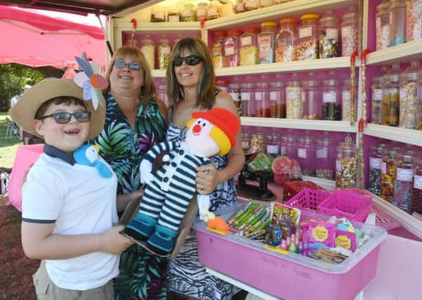 Family Fun Day at St George's Academy. L-R Wolf Mileham 8, Annie Mason and Brenda Mileham in front of Cottage Candy stall. EMN-180813-110643001