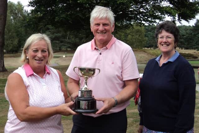 Rosemarie Lawton and Bob Boulton receive the Oldroyd Cup from club director Jane Salt (right) EMN-180813-093827002