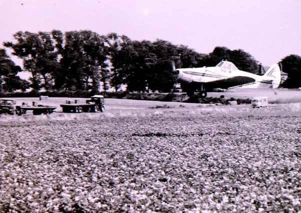 Aerial crop spraying blighted potato fields in Heckington in August 1969. EMN-180817-005551001
