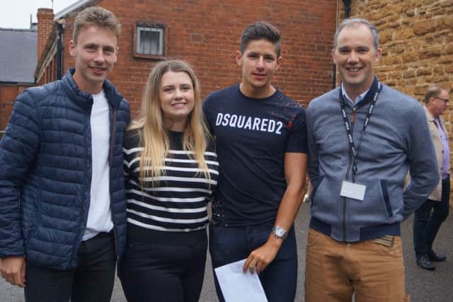 Caistor Grammar School headmaster Alistair Hopkins celebrates the school's success with students, from left, Tom Rollinson, who will be going to Leeds to study Geography; Lauren Shale, who will study histiry at Durham; and Jamie Caines, who will study mechanical engineering at Leeds. EMN-180816-093619001
