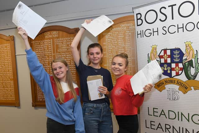 Savannah Hicks 17, Kitty Hooper 18, Bryony Smith 18, celebrate at Boston High School