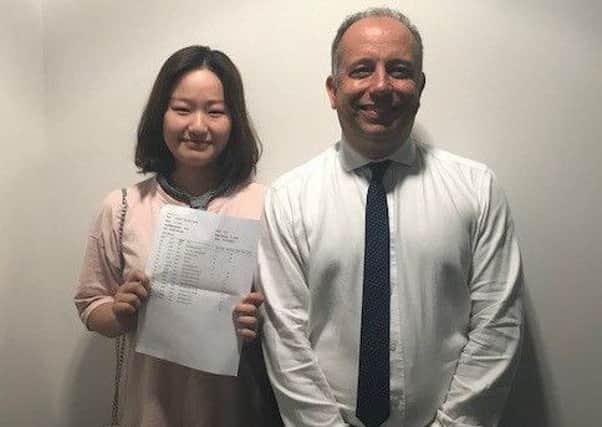 Lin Chen celebrating her A-level results at Skegness Academy with  the principal  Gary Carlile. ANL-180816-174258001