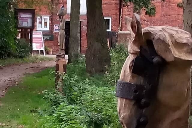 Mark Steadman's Dray Horse and Wayfarer post wood sculptures. EMN-180827-191511001