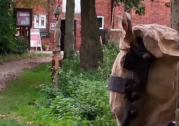 Mark Steadman's Dray Horse and Wayfarer post wood sculptures. EMN-180827-191511001