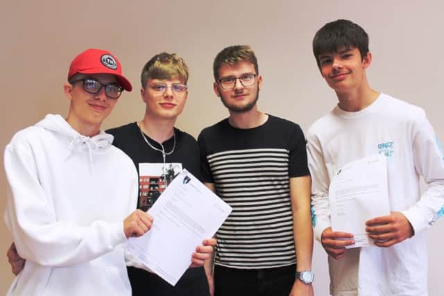 Ethan Robinson (left) and Kyle Hallgarth (right) collected their GCSE results this morning, supported by Ethan's brother Ashley Robinson and Kyle's cousin Daniel Coddington.