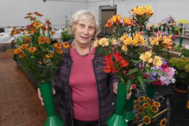 Show secretary Pat Rowett with her flower displays. EMN-180827-090919001