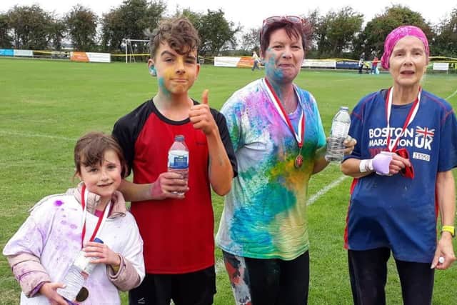 Benjamin Ailsby with sister and fellow Mablethorpe RC runners Lisa Musson and Felicity Burrow at the Alford Colour Run EMN-180827-125408002