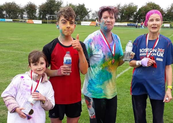 Benjamin Ailsby with sister and fellow Mablethorpe RC runners Lisa Musson and Felicity Burrow at the Alford Colour Run EMN-180827-125408002