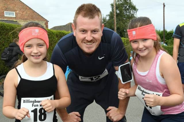 Charity 5 and 10k runs at Billingborough. Tom Harrison with Kiera Knight 9 (left) and Caitlyn Knight 11 (right) waiting for the start of the 5k run. EMN-180827-155910001