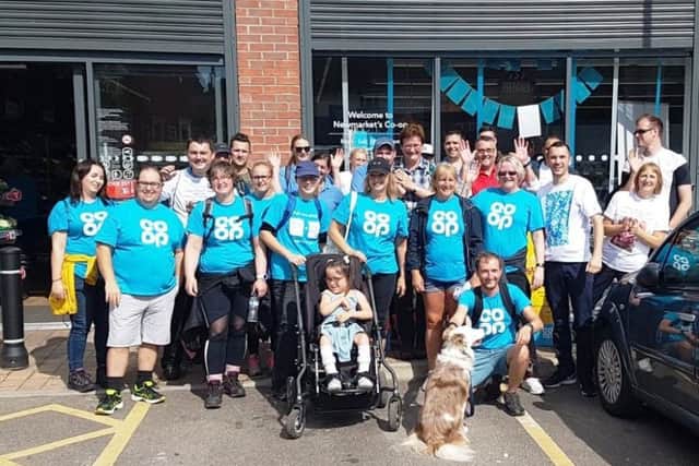 Leonie (6) and her family alongside Carol Garside, Co-op Store Manager who helped to organise the walk, Phil Cooper, Co-op Area Manager, and Co-op colleagues.