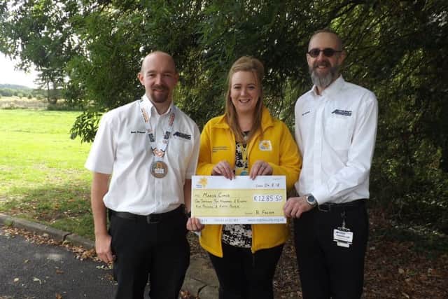Presenting his donation. From left - Ben Frazer, Lauren Alexander - Community Fundraiser for Marie Curie Lincolnshire and John Seaton. EMN-180309-144602001