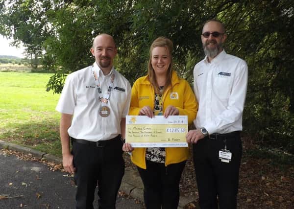 Presenting his donation. From left - Ben Frazer, Lauren Alexander - Community Fundraiser for Marie Curie Lincolnshire and John Seaton. EMN-180309-144602001