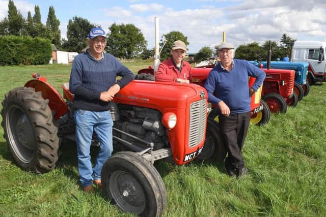 Fun Day at Billinghay for Lincs and NOtts Air Ambulance. L-R Nigel Taylor, Charles Smith 16 and Ray Parrish with Ray's 1963 Massy Fergusson 35X. EMN-180827-093629001