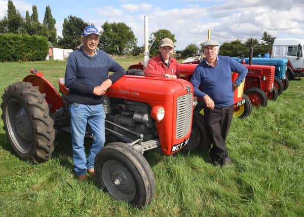 Fun Day at Billinghay for Lincs and NOtts Air Ambulance. L-R Nigel Taylor, Charles Smith 16 and Ray Parrish with Ray's 1963 Massy Fergusson 35X. EMN-180827-093629001