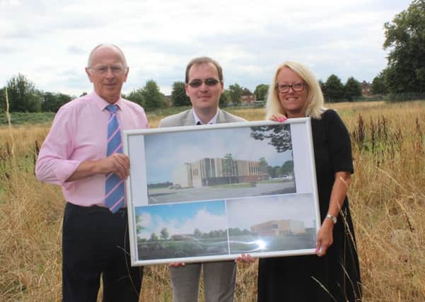 Coun Jeff Summers, Coun Thomas Smith and Karen Whitfield with the leisure centre plans.