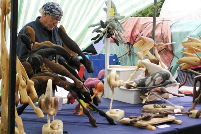Pictured above is Paul Hempsall with his amazing wooden animals.